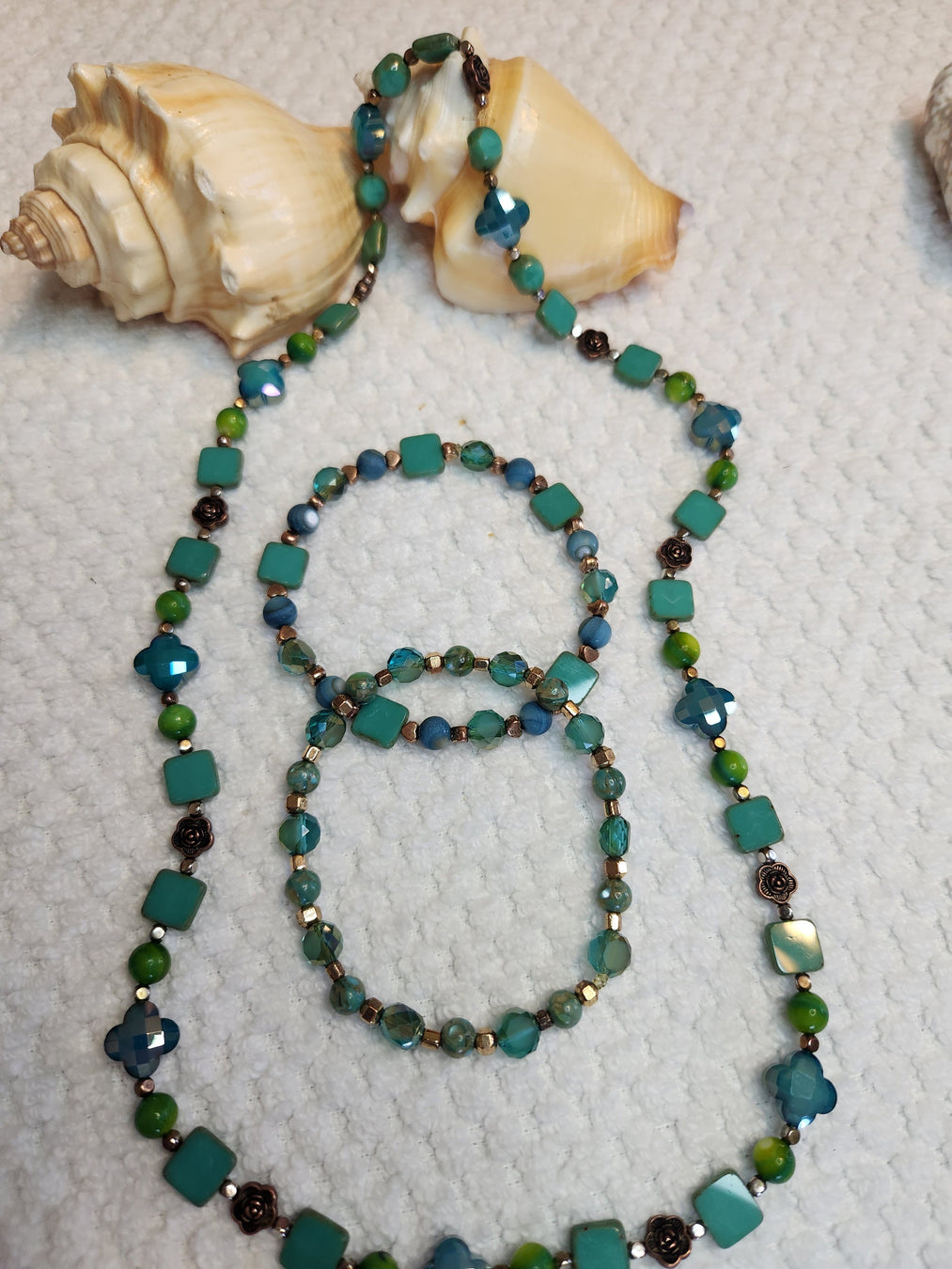 A Turquoise Colored Necklace and Bracelet Set